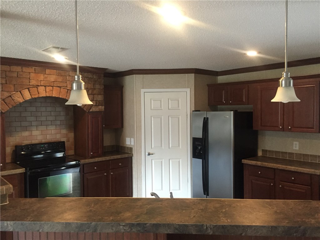 35611 Quail Road Callahan, FL 32011 - Photo 4 of 22 a kitchen with stainless steel appliances granite countertop a refrigerator and a sink