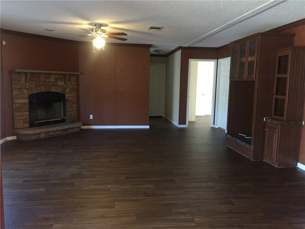 35611 Quail Road Callahan, FL 32011 - Photo 7 of 22 a view of a livingroom with wooden floor and a fireplace