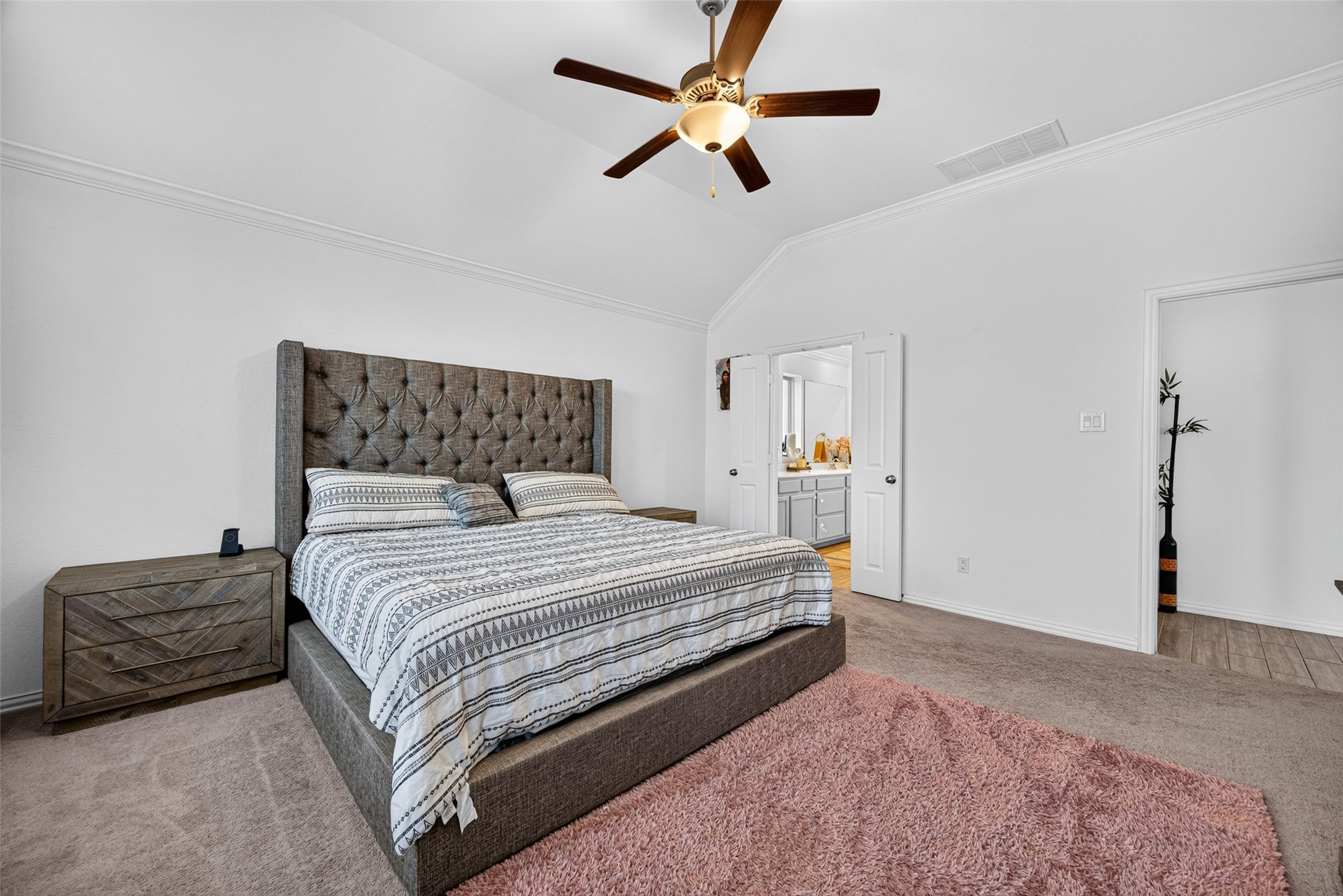 4441 Jessamine Creek Trail Rosharon, TX 77583 - Photo 27 of 42 The spacious primary bedroom creates a relaxing retreat with a vaulted ceiling, crown molding, and plenty of natural light.
