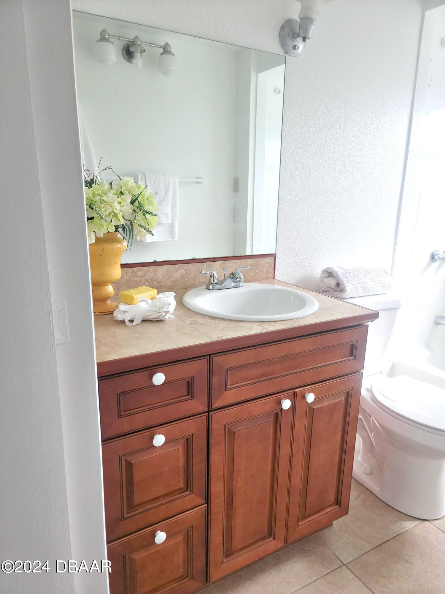134 Douglas Street Edgewater, FL 32141 - Photo 12 of 20 a bathroom with a granite countertop sink and a mirror
