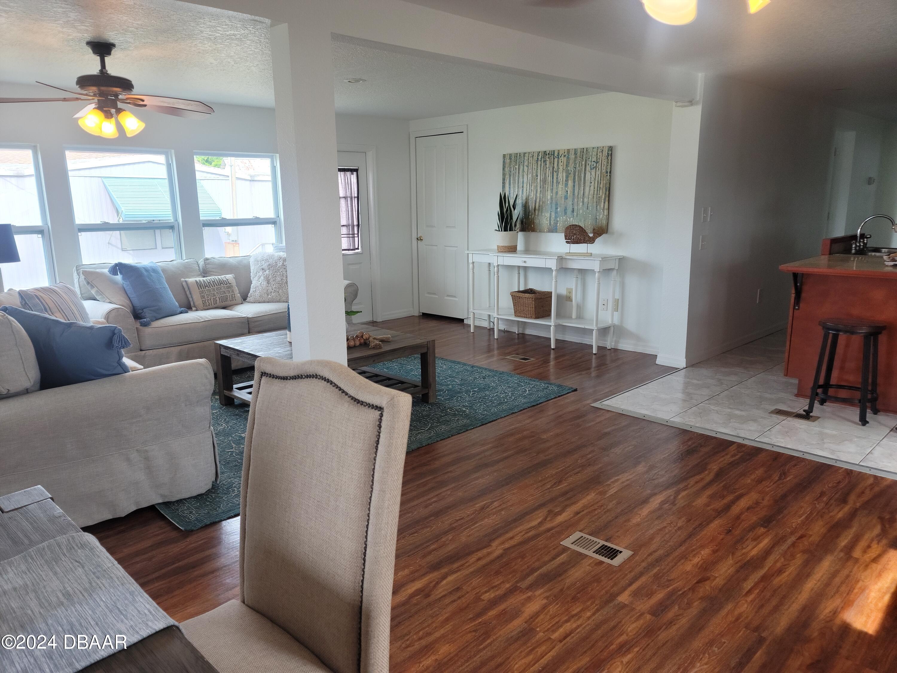 134 Douglas Street Edgewater, FL 32141 - Photo 6 of 20 a living room with furniture and a painting on the wall