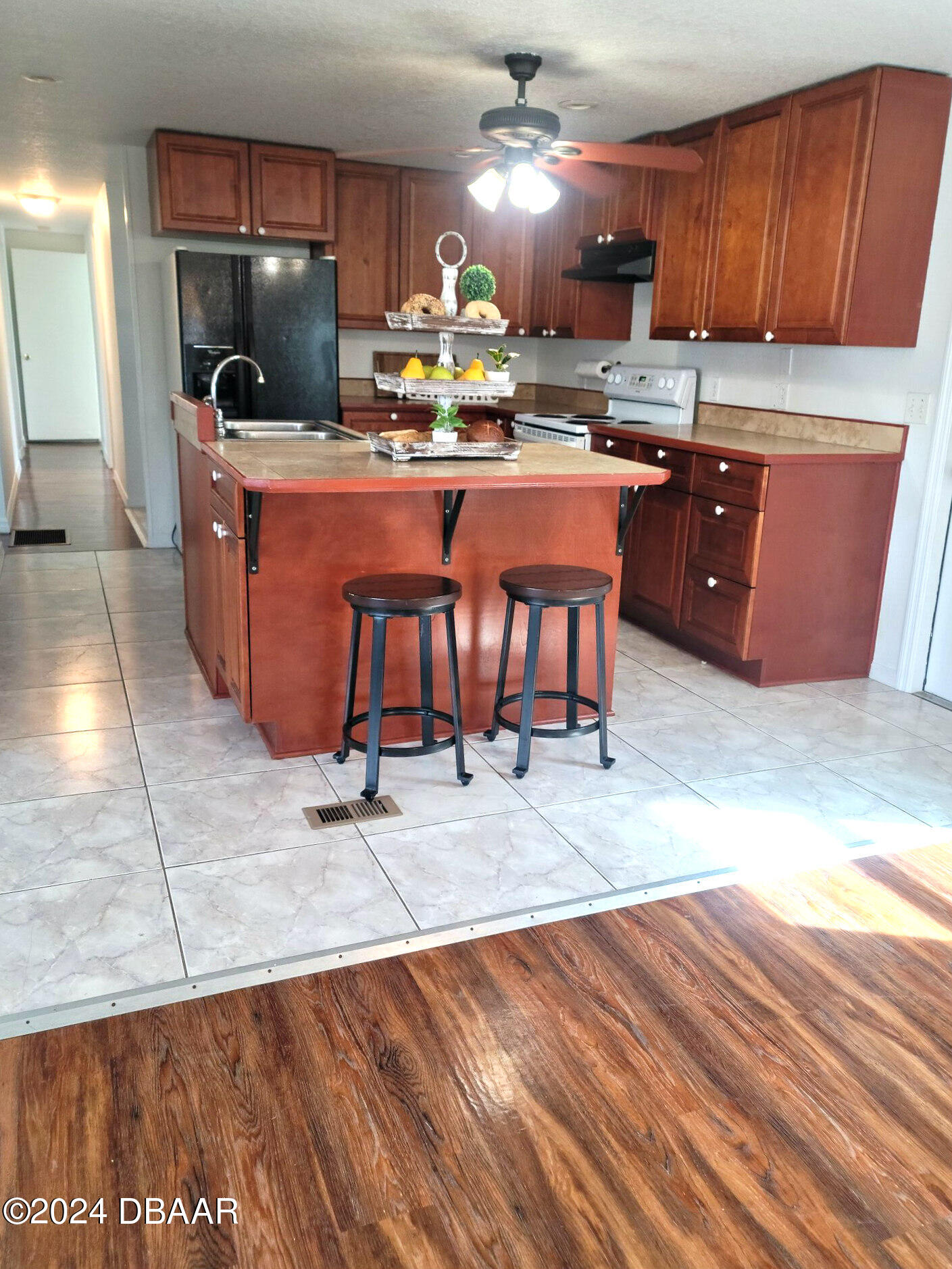 134 Douglas Street Edgewater, FL 32141 - Photo 9 of 20 a kitchen with stainless steel appliances granite countertop a sink and a refrigerator