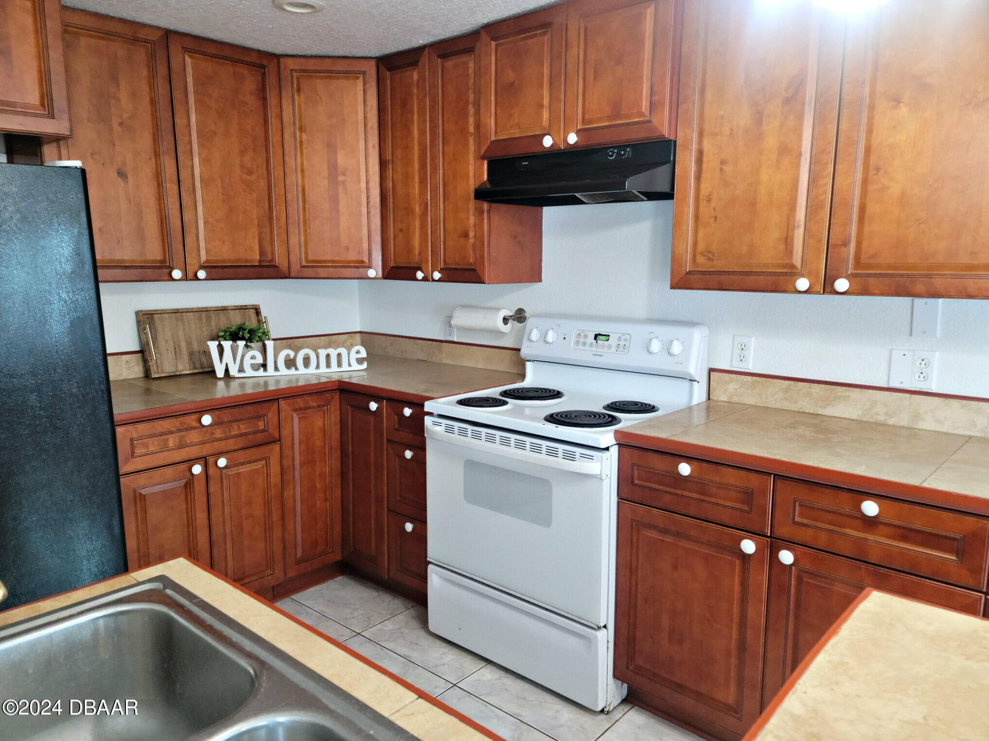 134 Douglas Street Edgewater, FL 32141 - Photo 10 of 20 a kitchen with stainless steel appliances granite countertop a sink stove and cabinets
