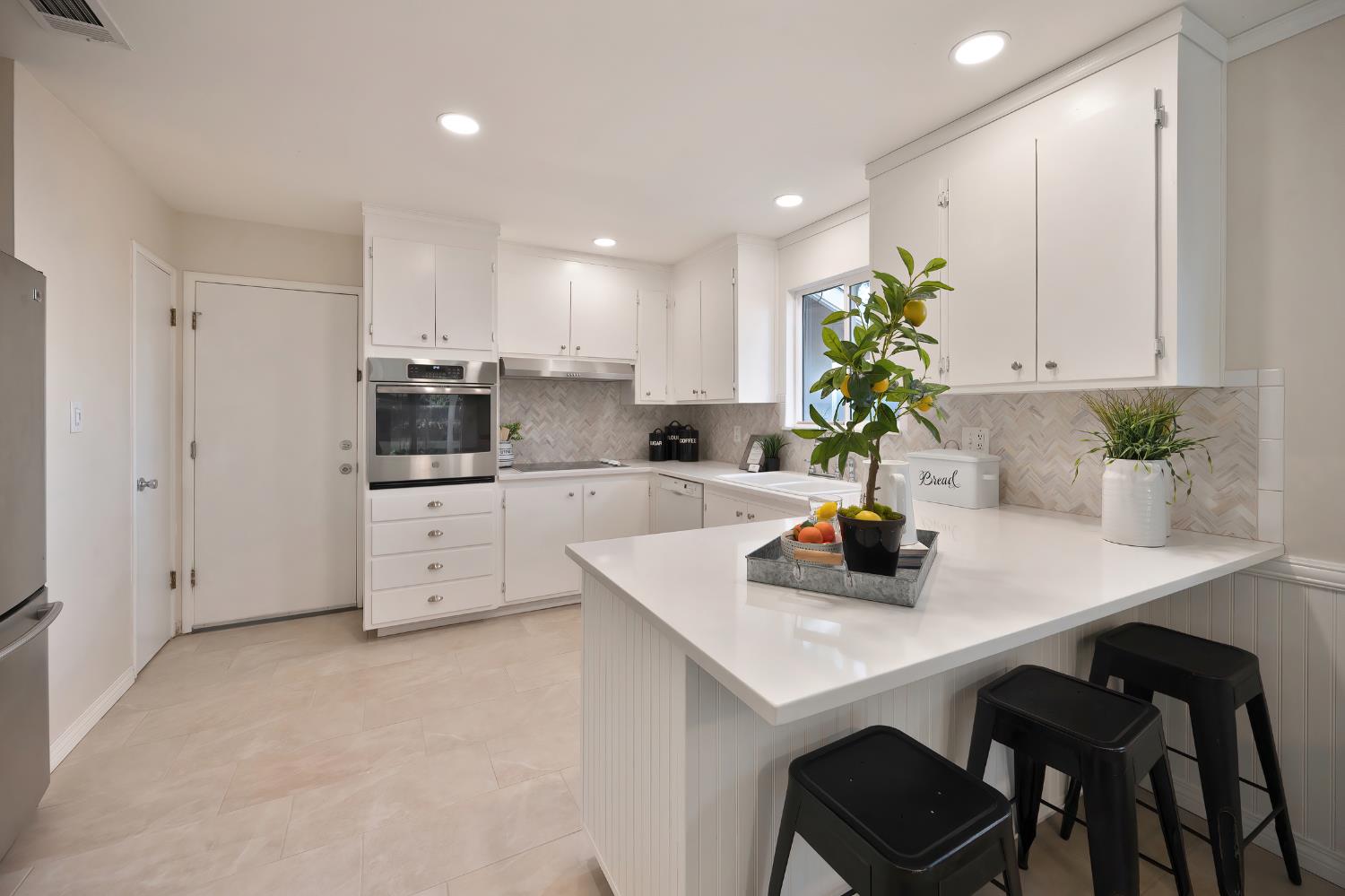 2329 Sabine Way Rancho Cordova, CA 95670 - Photo 6 of 21 a kitchen with a sink a stove and cabinets