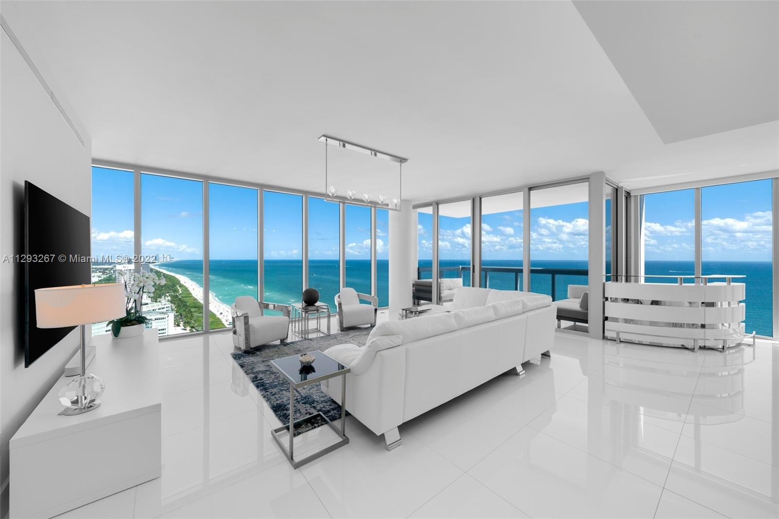 6899 Collins Avenue, Unit 3104 Miami Beach, FL 33141 - Photo 1 of 38 a living room with furniture and large windows
