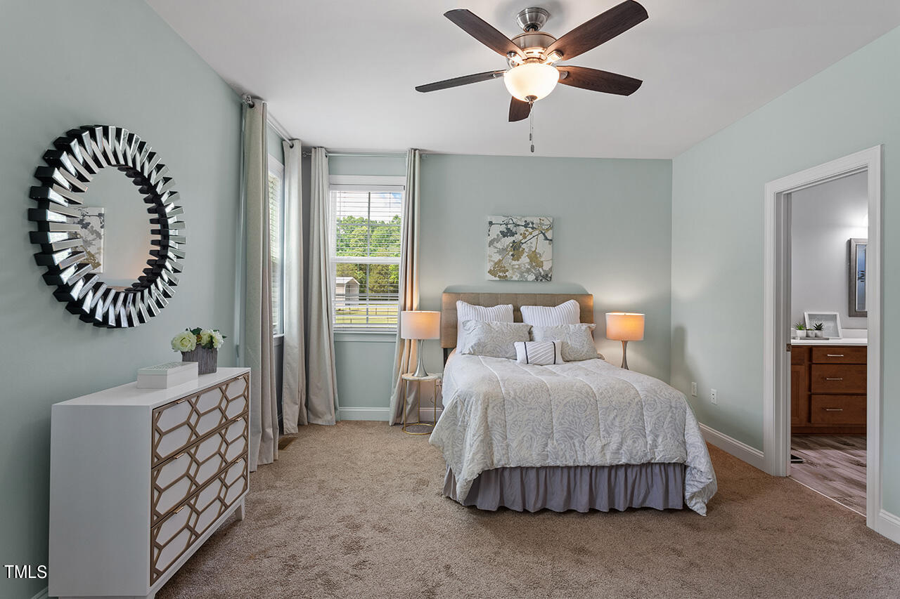3925 Billy Hopkins Road Zebulon, NC 27597 - Photo 14 of 40 a bedroom with a bed and a window