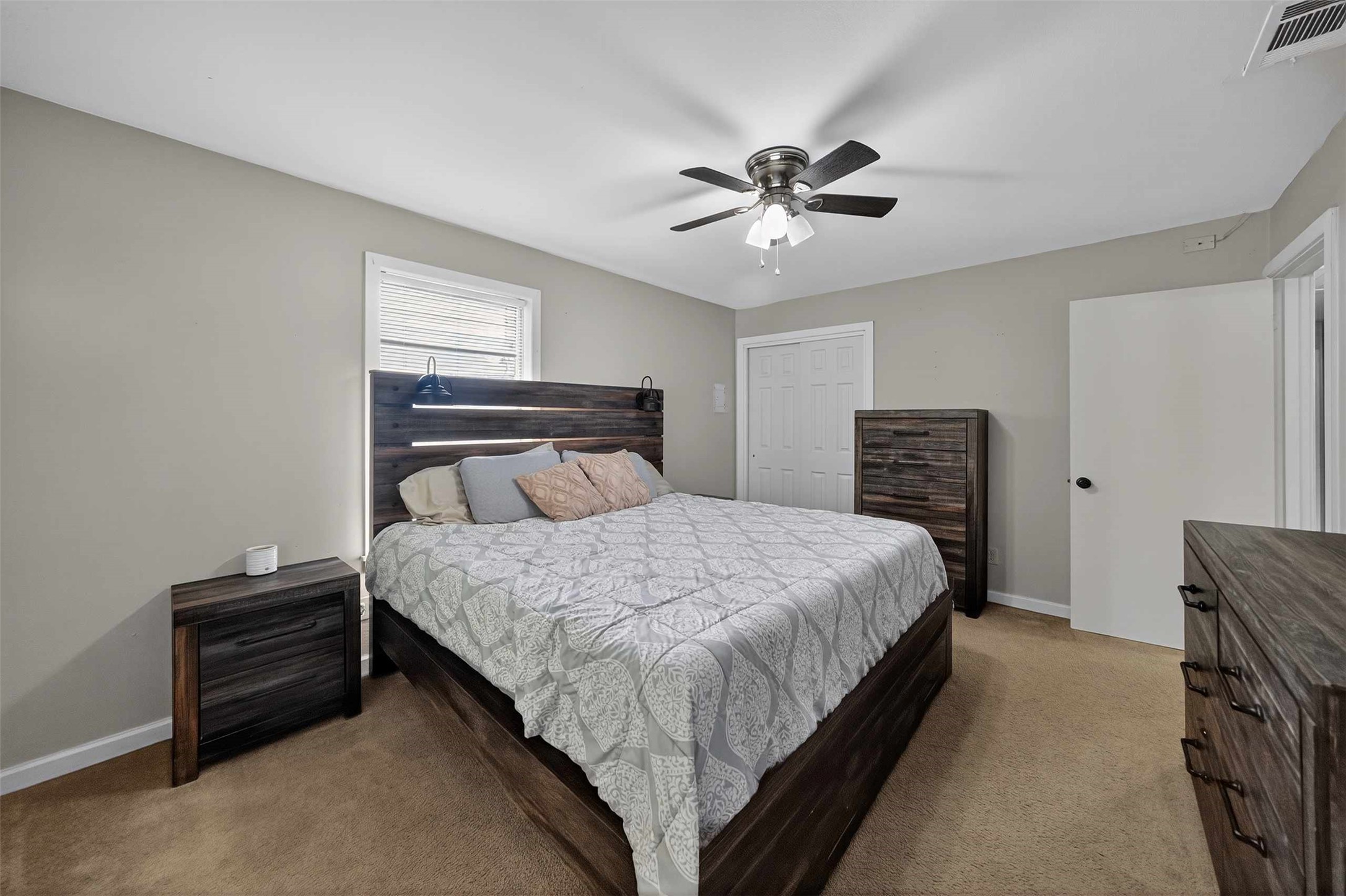 306 4th Street Palestine, TX 75803 - Photo 14 of 34 a bedroom with a bed and a chandelier