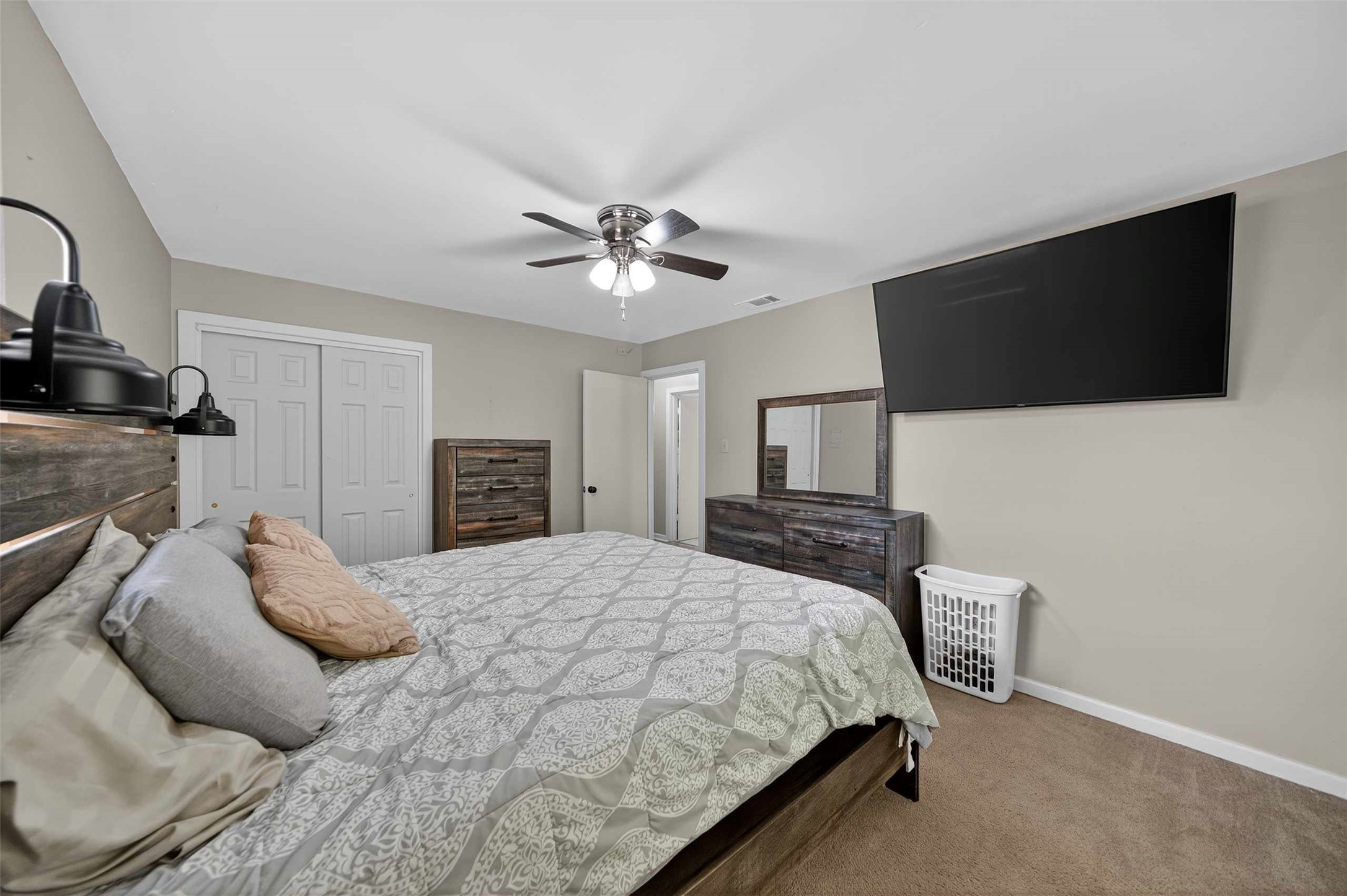 306 4th Street Palestine, TX 75803 - Photo 15 of 34 a bedroom with a large bed and a flat screen tv