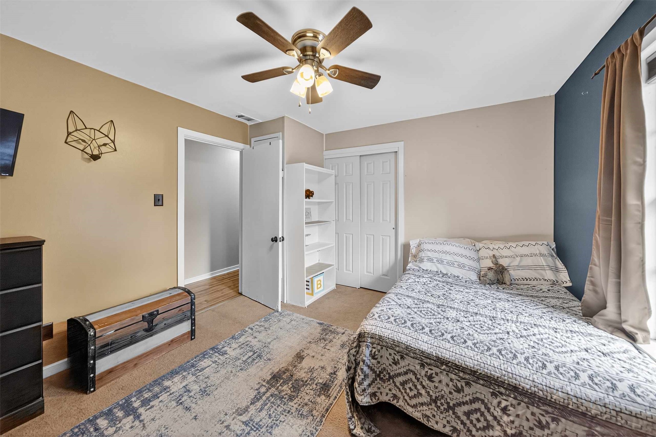 306 4th Street Palestine, TX 75803 - Photo 23 of 34 a bedroom with a bed and a chandelier