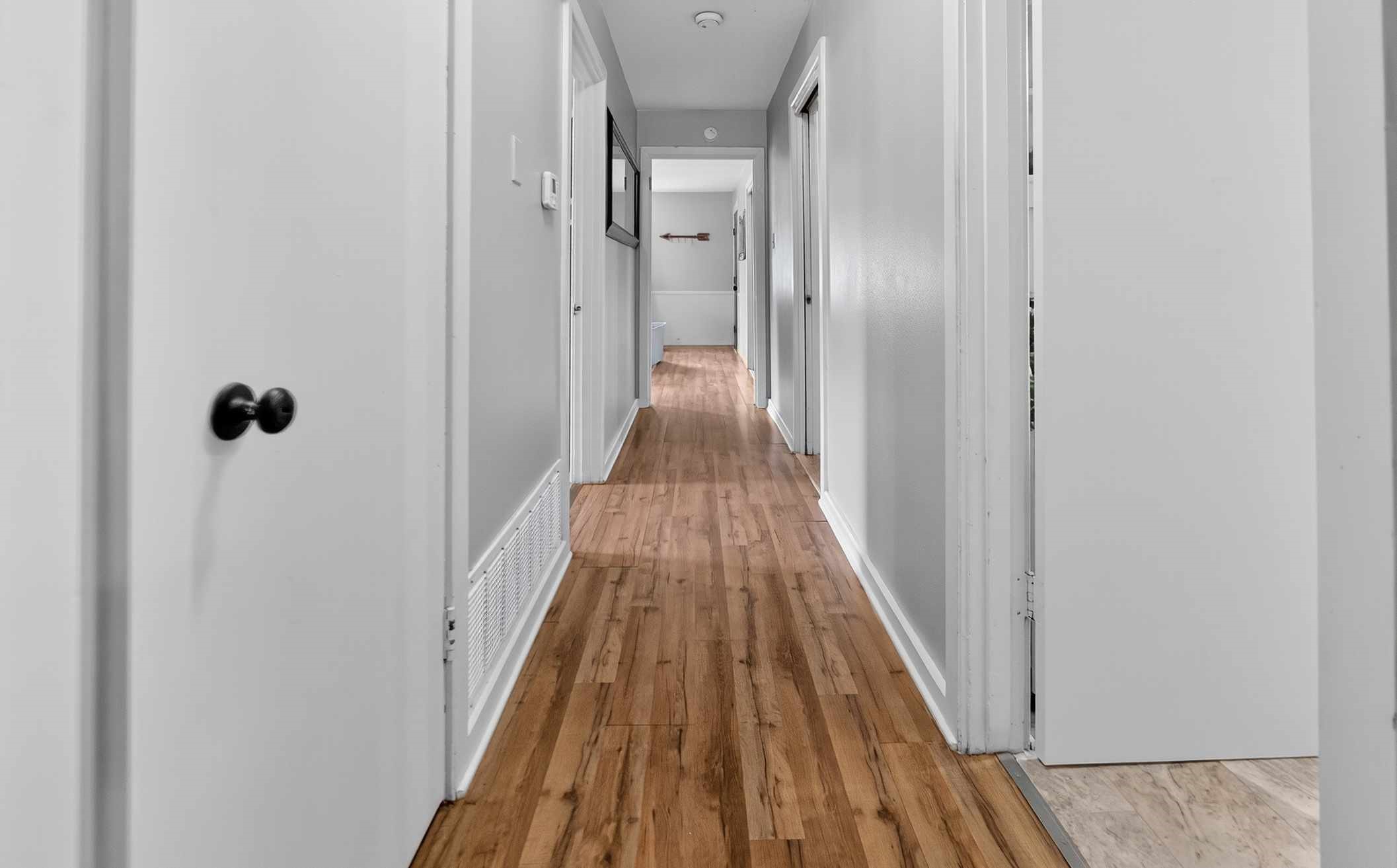 306 4th Street Palestine, TX 75803 - Photo 9 of 34 a view of a hallway with wooden floor and a bathroom