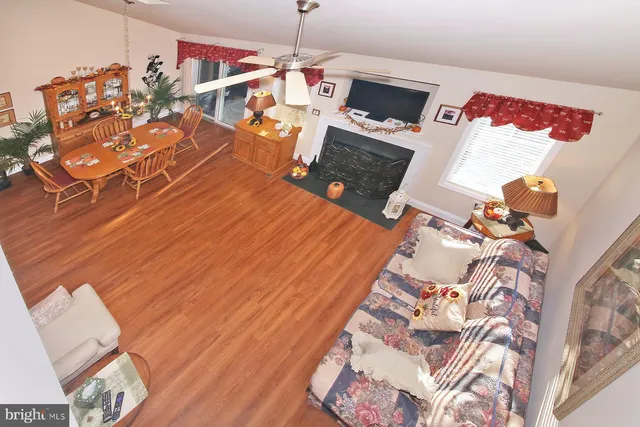 a bedroom with a bed a dresser and potted plants