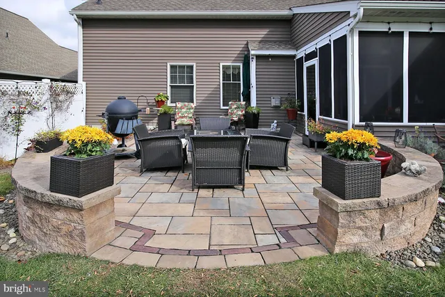 a living room with a couch and potted plants