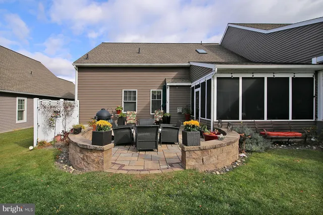 a backyard of a house with yard and outdoor seating