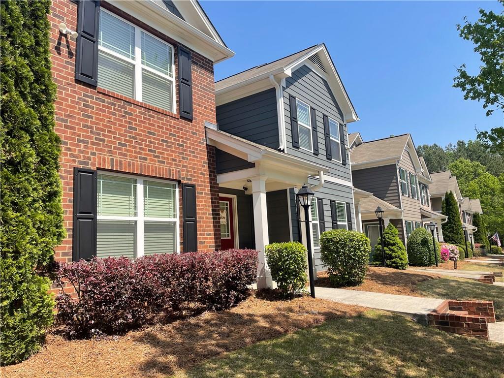 front view of a brick house with a yard