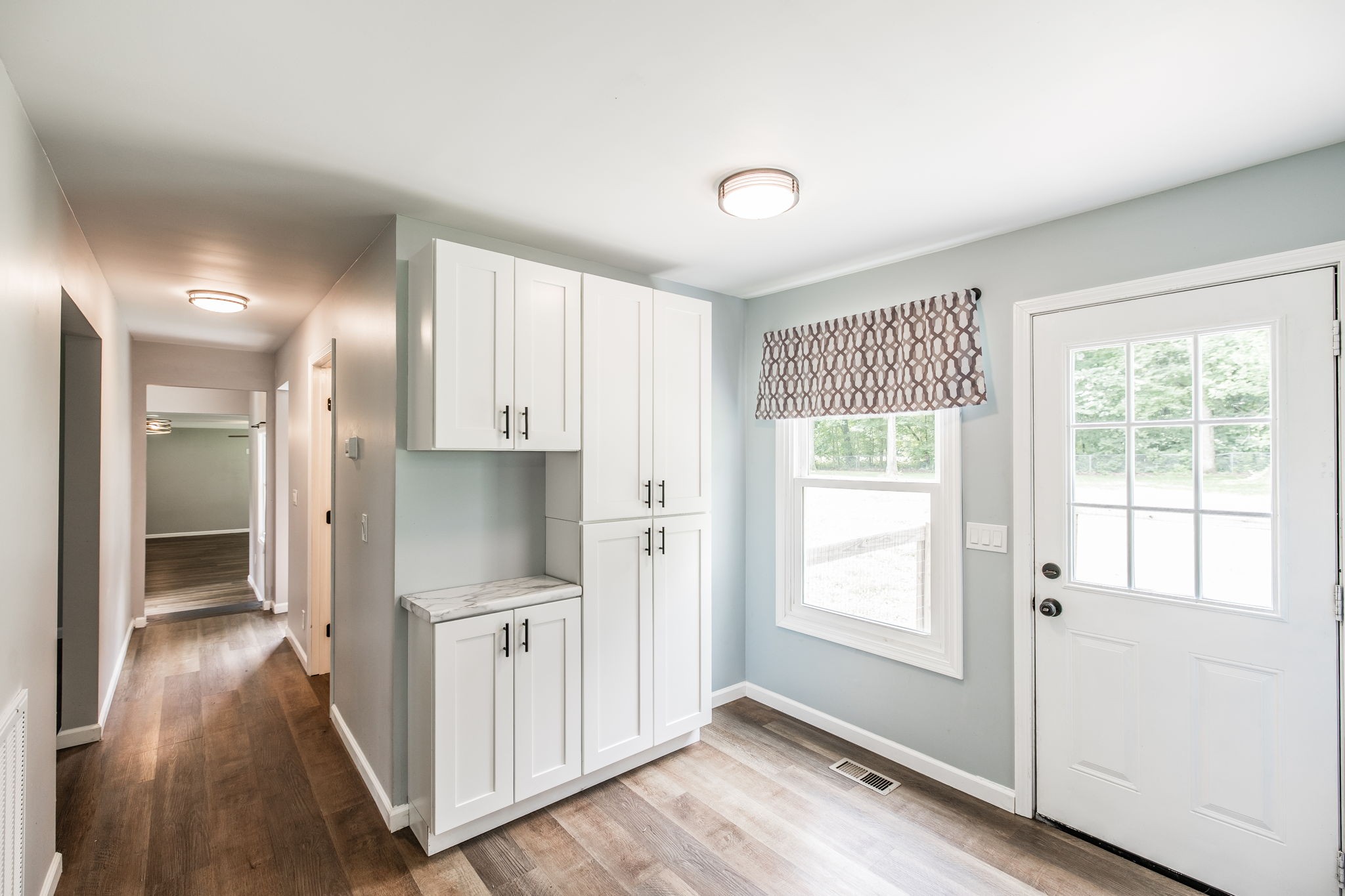 13989 Owens Chapel Road Springfield, TN 37172 - Photo 9 of 43 a view of a hallway with wooden floor and a bathroom