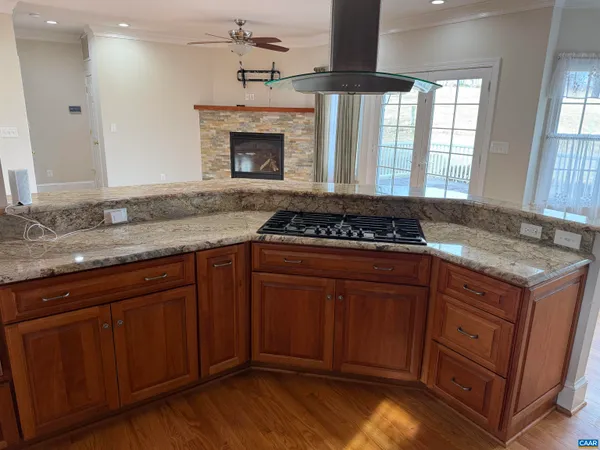 a kitchen with granite countertop a stove and a sink
