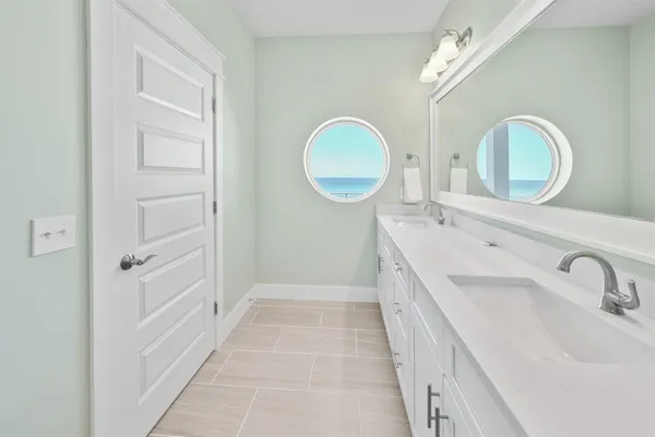 a bathroom with a double vanity sink and a mirror
