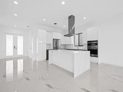 a large kitchen with white cabinets
