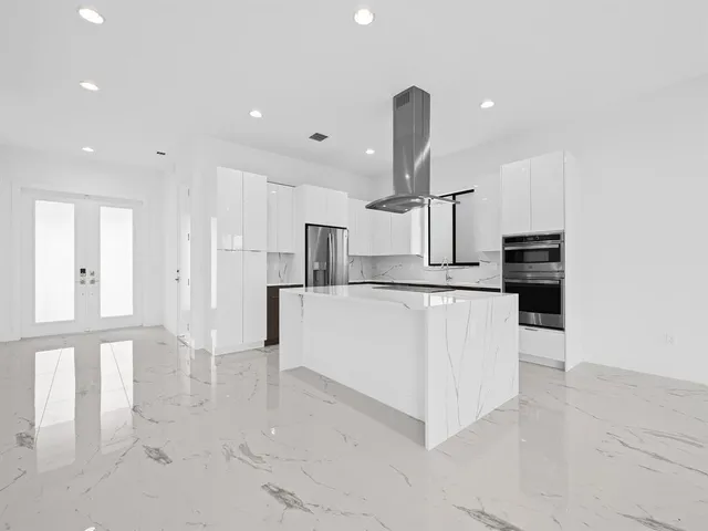 a large kitchen with white cabinets