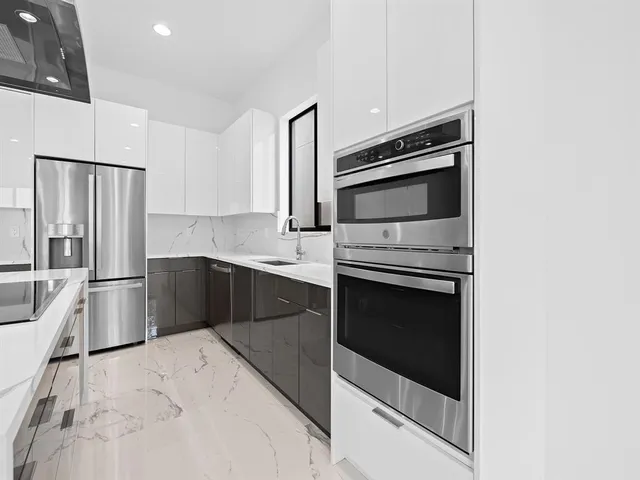 a kitchen with granite countertop cabinets and steel stainless steel appliances
