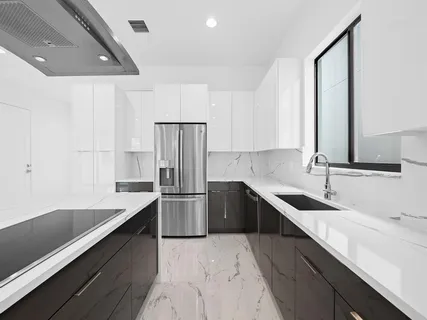 a kitchen with a sink appliances and cabinets