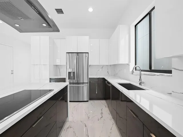 a kitchen with a sink appliances and cabinets
