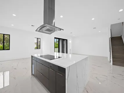 a kitchen with a sink a counter space and appliances