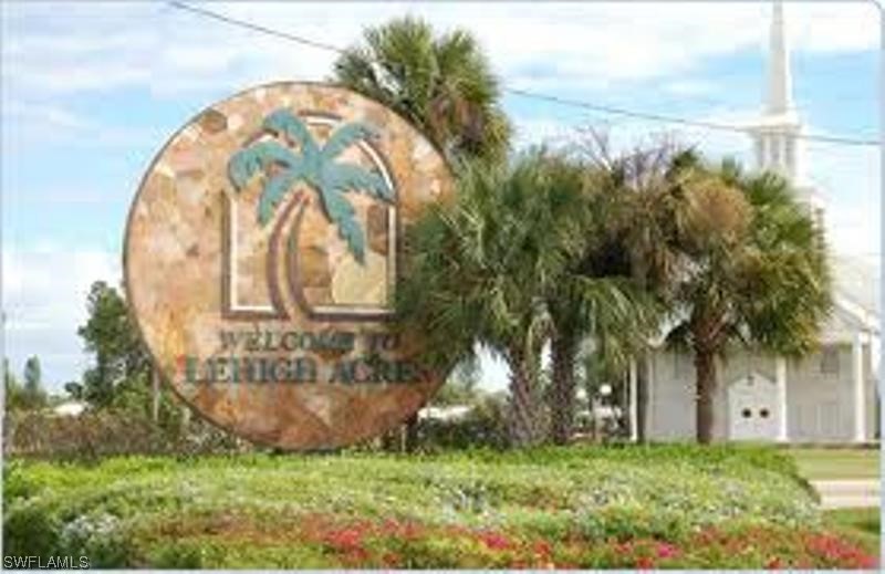 3226 Meadow Road Lehigh Acres, FL 33974 - Photo 4 of 5 a garden view with a fountain