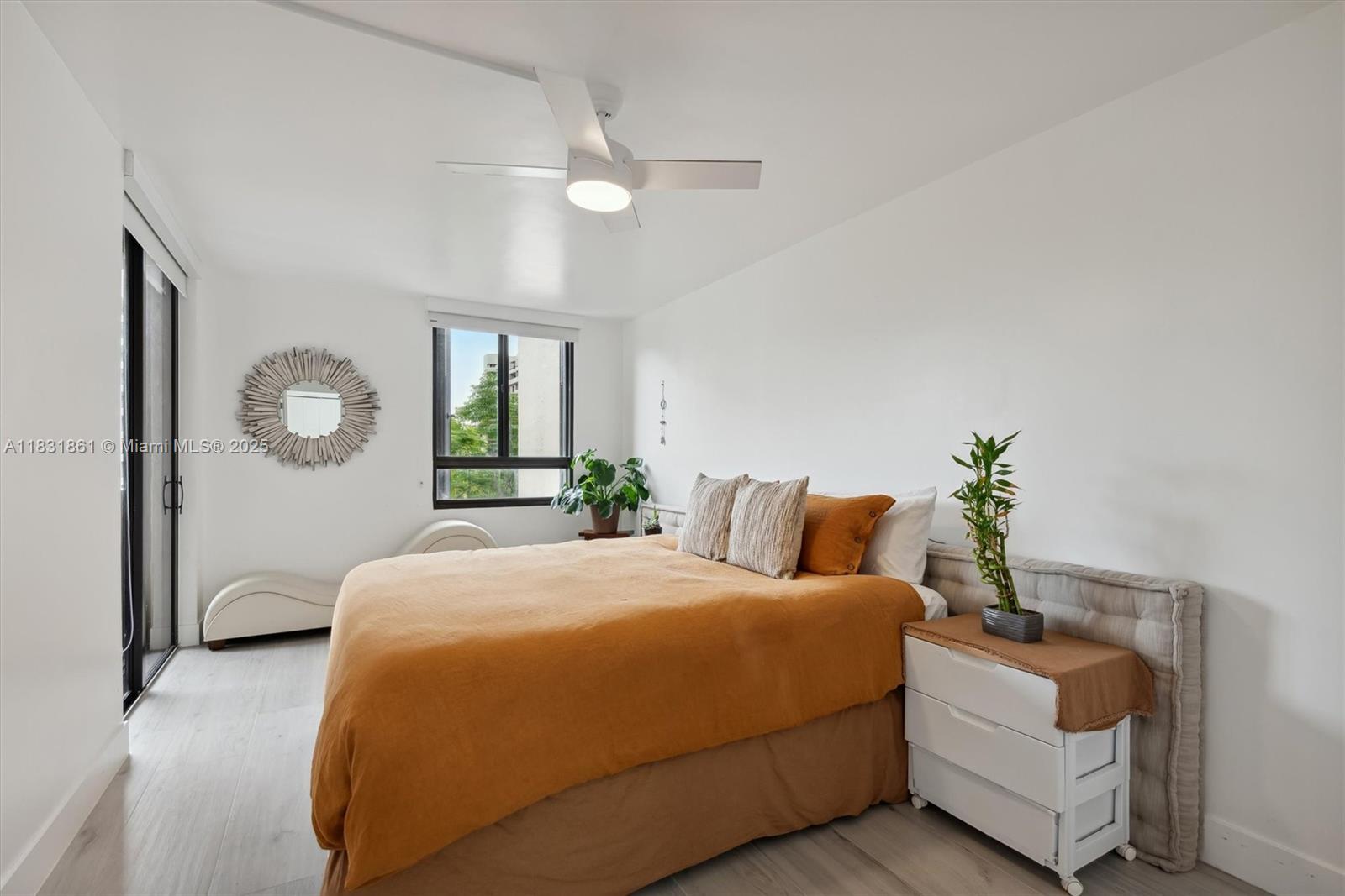 161 Crandon Boulevard, Unit 412 Key Biscayne, FL 33149 - Photo 14 of 15 a bedroom with a large bed and a chandelier