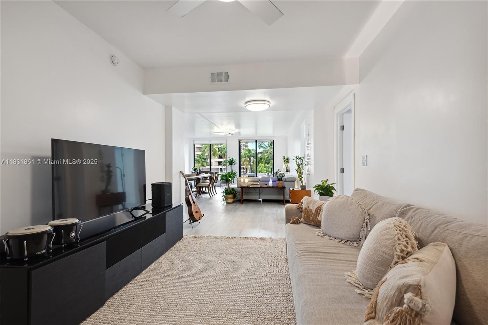 161 Crandon Boulevard, Unit 412 Key Biscayne, FL 33149 - Photo 4 of 15 a living room with furniture and a flat screen tv