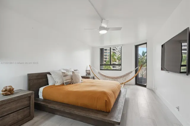 a living room with furniture and floor to ceiling windows