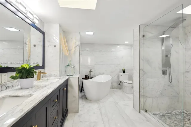 a living room with furniture potted plant and a large window