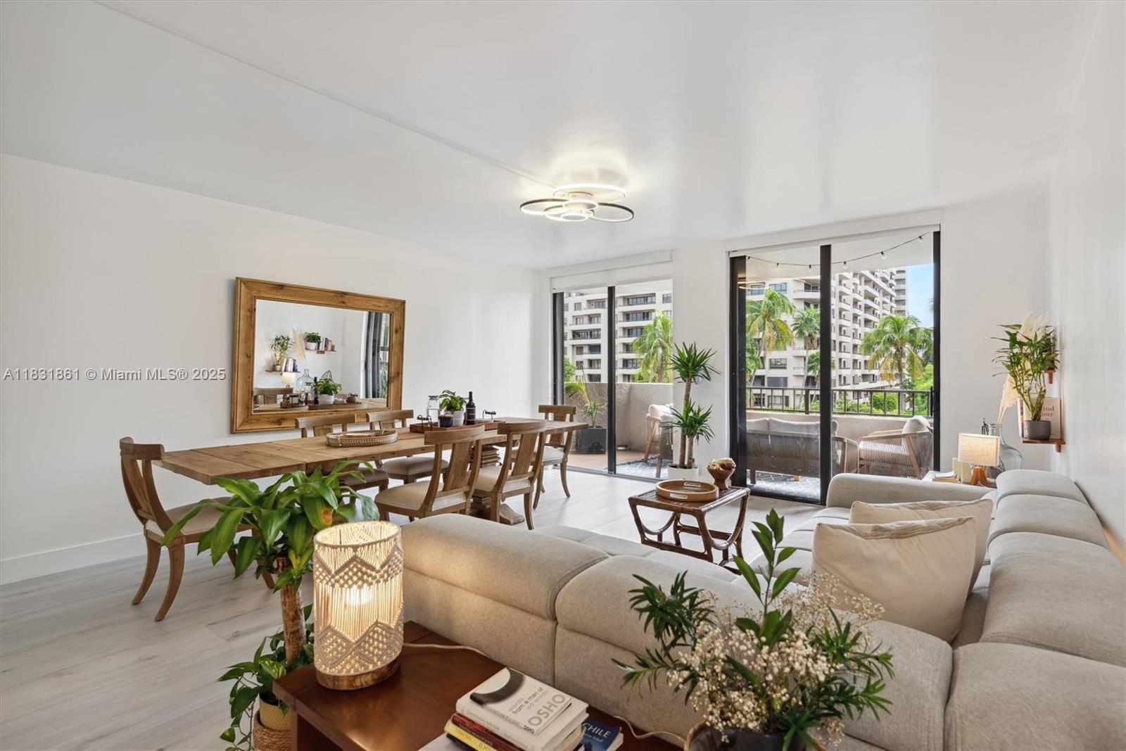 161 Crandon Boulevard, Unit 412 Key Biscayne, FL 33149 - Photo 8 of 15 a living room with furniture potted plant and a large window