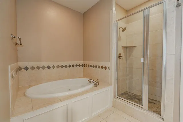 a bathroom with a bathtub and a shower