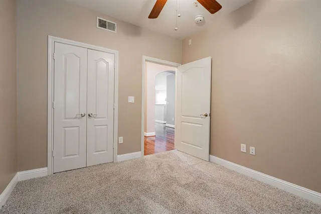 an empty room with an entryway and closet