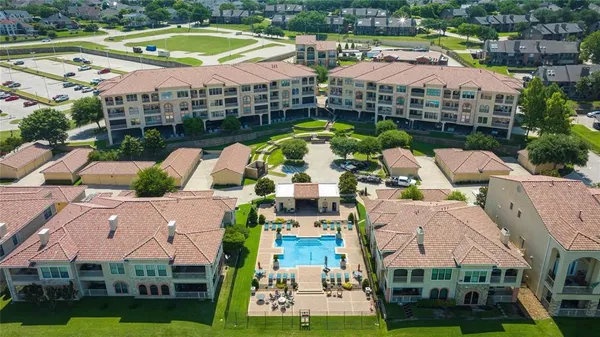 a aerial view of multiple houses with yard