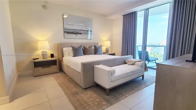 a bedroom with a bed and a large window