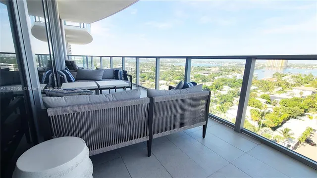 a living room with furniture and a floor to ceiling window