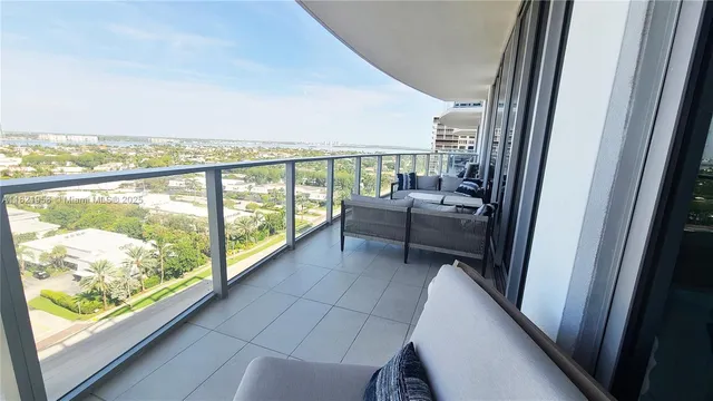 a view of a balcony with couch and city view