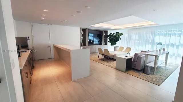 a living room with furniture a window and a flat screen tv