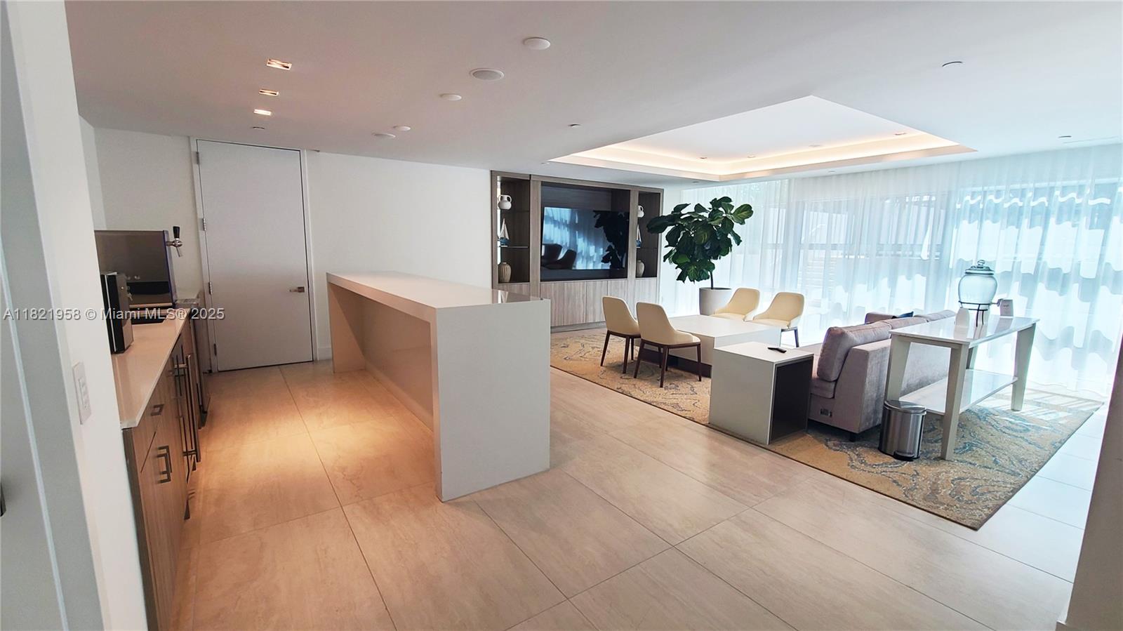 3100 North Ocean Drive, Unit 1206 Singer Island, FL 33404 - Photo 28 of 40 a living room with furniture a window and a flat screen tv