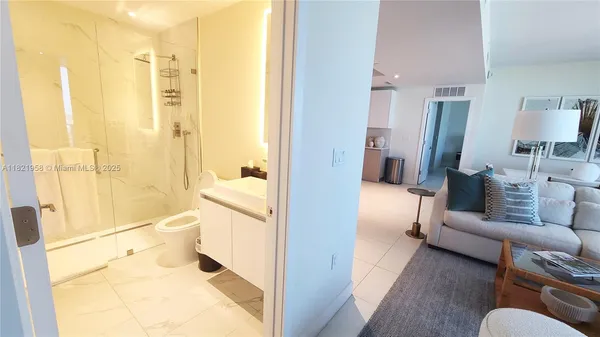 a bathroom with a tub shower and a sink
