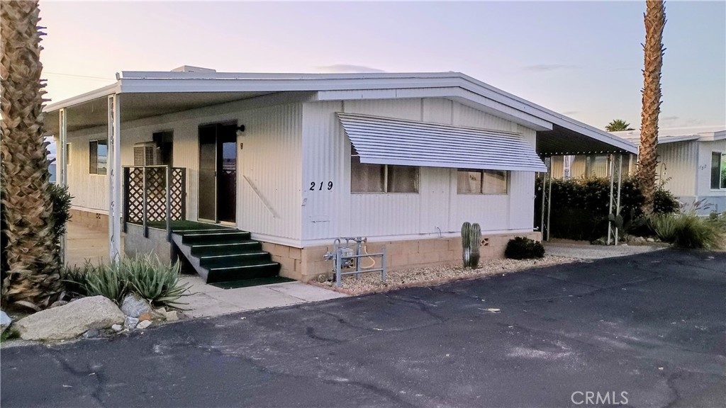 17800 Langlois Road Desert Hot Springs, CA 92241 - Photo 1 of 19 a front view of a house with a yard