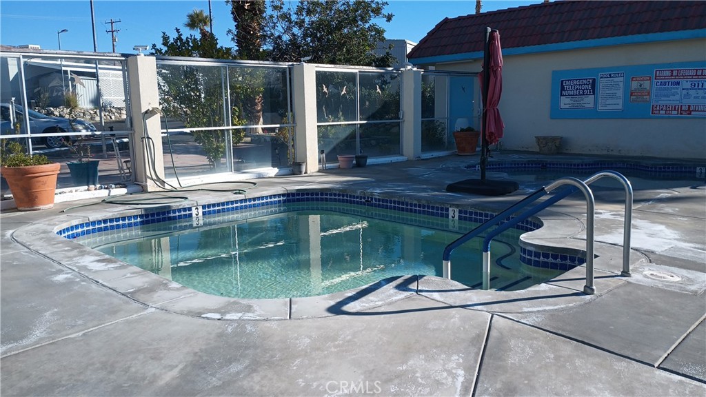 17800 Langlois Road Desert Hot Springs, CA 92241 - Photo 14 of 19 a swimming pool with some trees in the background