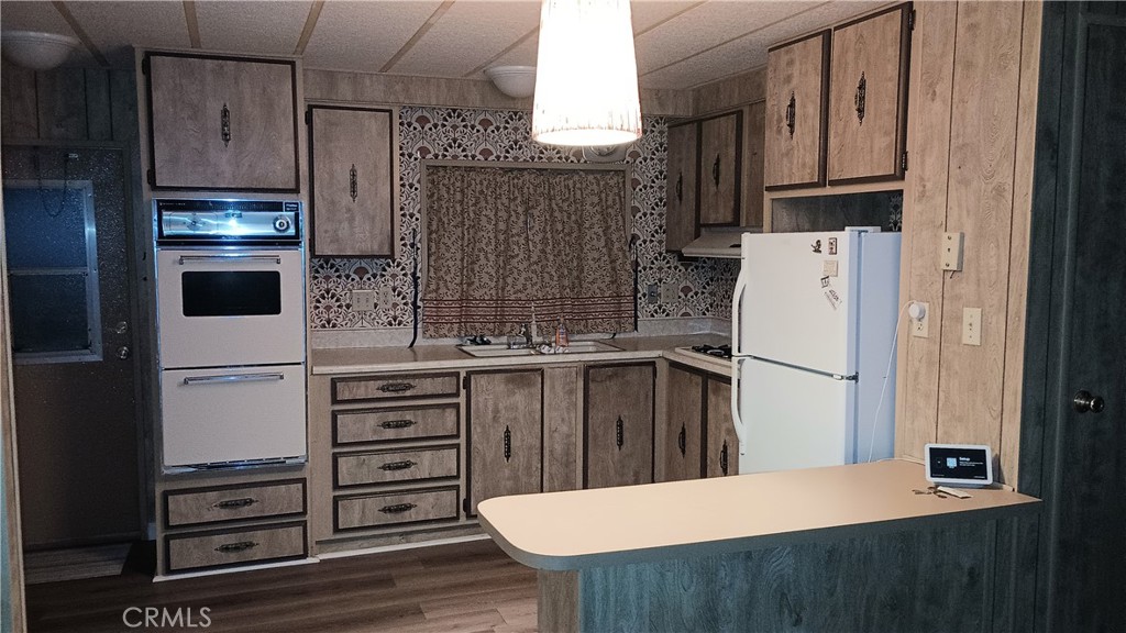17800 Langlois Road Desert Hot Springs, CA 92241 - Photo 4 of 19 a kitchen with cabinets and stainless steel appliances