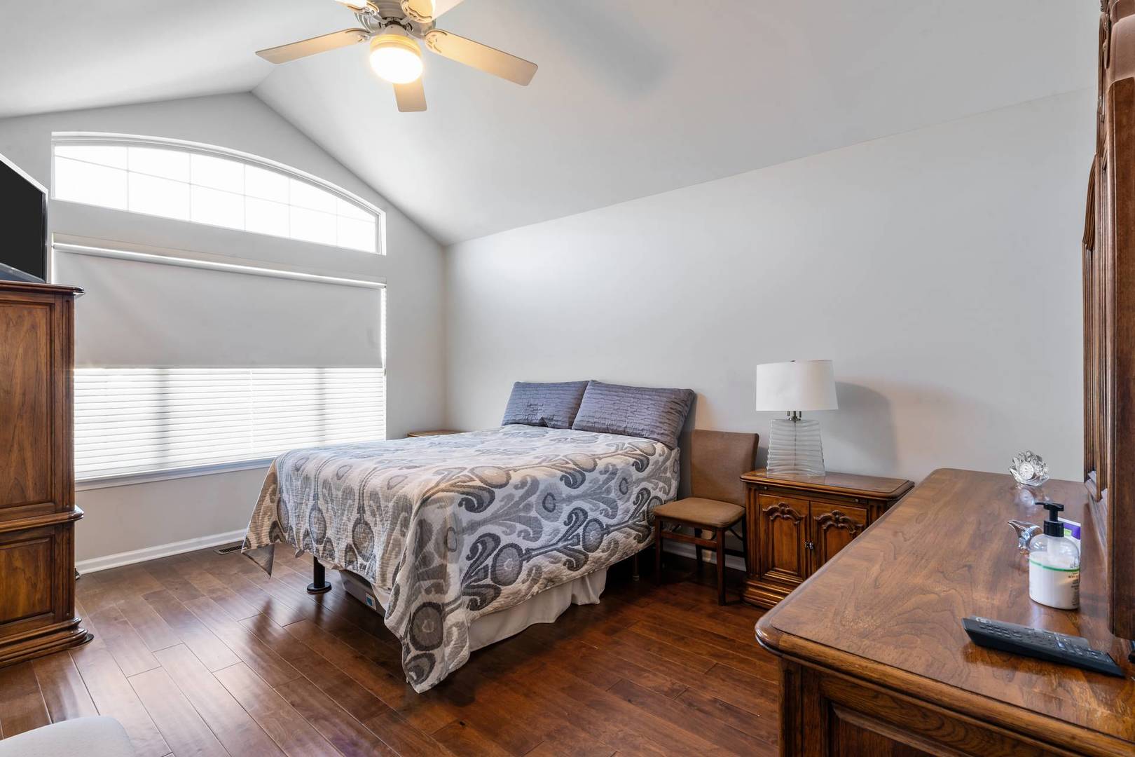 232 Manor Drive Buffalo Grove, IL 60089 - Photo 15 of 21 a bedroom with a bed and a chandelier