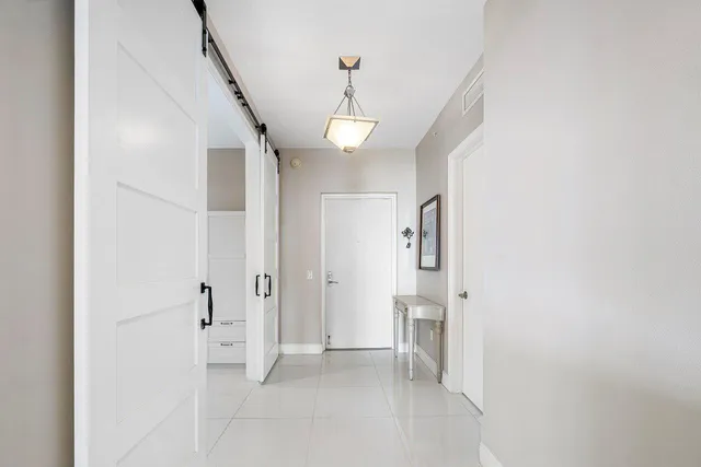 a view of a hallway with wooden floor and entryway