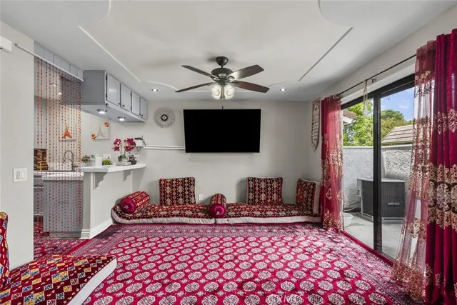 a bedroom with furniture a flat screen tv and a chandelier