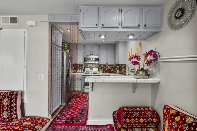 a kitchen with stainless steel appliances a sink stove and cabinets
