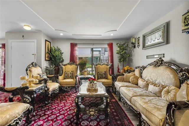 a living room with furniture floor to ceiling window and a flat screen tv